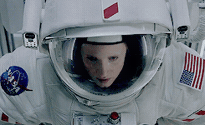 Woman In NASA Space Suit Looking At Camera GIF