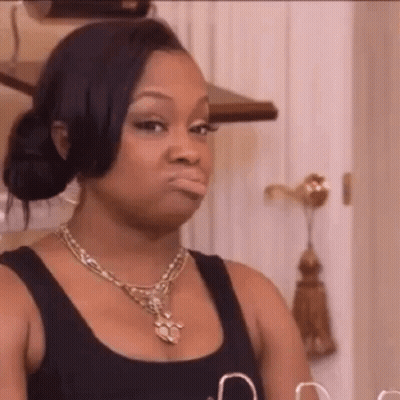Woman In Necklace And Black Tank Top Making A Face GIF