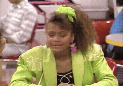 Woman In Neon Green Jacket Sitting At Restaurant Table GIF