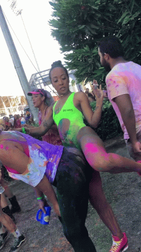 Woman In Neon Green Swimsuit Lifted By Man GIF
