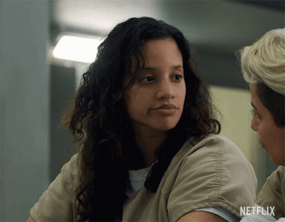 Woman In Netflix Uniform Looking At Camera GIF