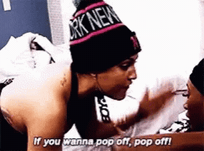 Woman In New York Beanie Talking To Another GIF