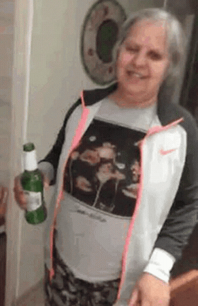 Woman In Nike Jacket Holding Beer Bottle GIF
