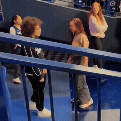 Woman In Nike Shirt Next To Girl GIF