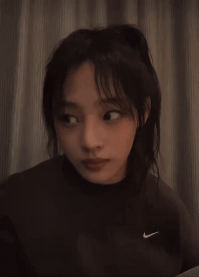 Woman In Nike Sweatshirt Looking At Camera GIF