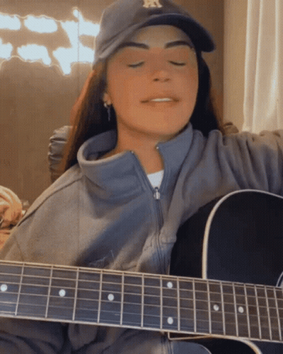 Woman In NY Yankees Hat Playing Acoustic Guitar GIF