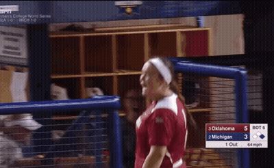 Woman In Oklahoma Softball Jersey In Front Of Scoreboard GIF
