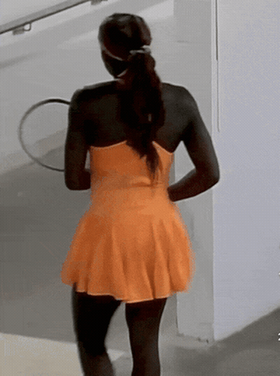 Woman In Orange Dress Holding Tennis Racquet GIF