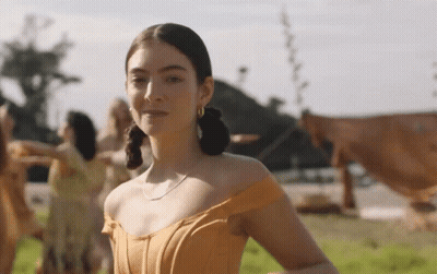 Woman In Orange Dress In Field GIF