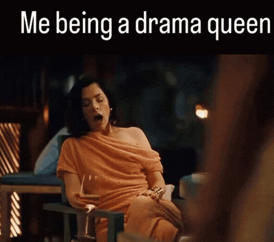Woman In Orange Dress Yawning With Glass Of Wine GIF