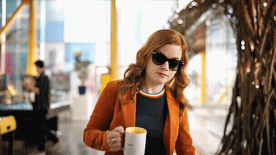 Woman In Orange Jacket Holding I Love You Mug GIF