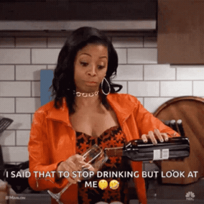 Woman In Orange Jacket Pouring Wine Into Glass GIF