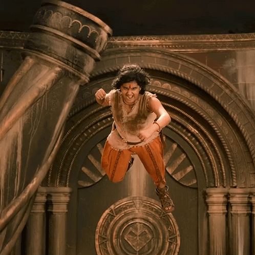Woman In Orange Pants Standing In Front Of Horn GIF