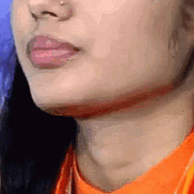 Woman In Orange Shirt Close Up GIF