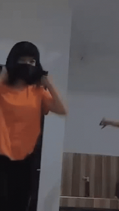 Woman In Orange Shirt Dancing With Another GIF