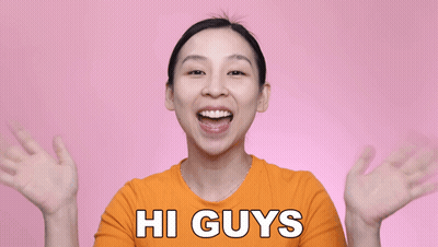 Woman In Orange Shirt Saying Hi GIF