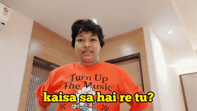 Woman In Orange Shirt Saying Turn Up The Music GIF