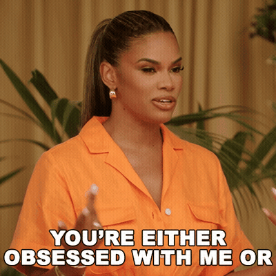 Woman In Orange Shirt Saying You're Obsessed GIF