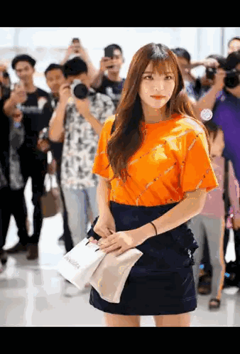 Woman In Orange Shirt Standing Sticker