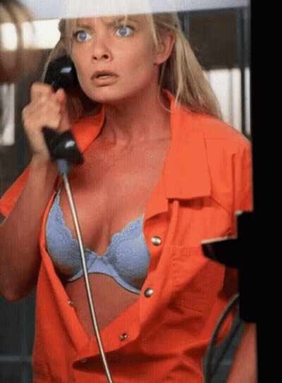 Woman In Orange Shirt Talking On Phone GIF