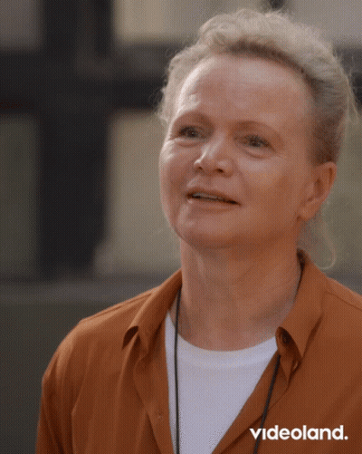 Woman In Orange Shirt With Videoland Text GIF