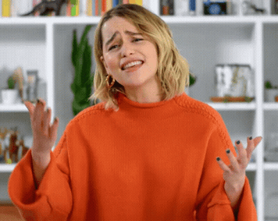 Woman In Orange Sweater Making Funny Face GIF
