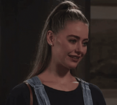 Woman In Overalls And Black Shirt Smiling GIF