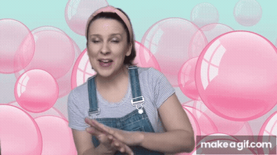 Woman In Overalls Surrounded By Pink Bubbles Says Make A GIF