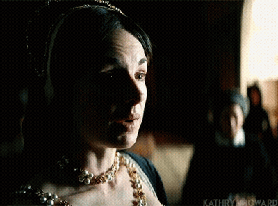 Woman In Pearl Necklace And Crown Standing In Dark GIF