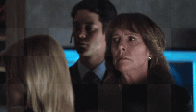 Woman In Pearl Necklace In Dark Room GIF