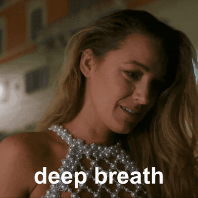 Woman In Pearl Top Saying Deep Breath GIF