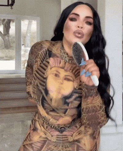 Woman In Pharaoh Dress Brushing Hair GIF
