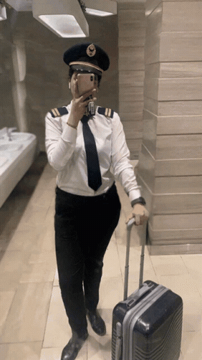 Woman In Pilot Uniform Taking Selfie GIF