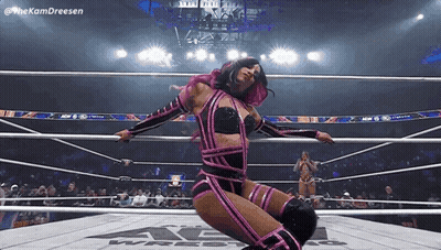 Woman In Pink And Black Wrestling Outfit Kneeling In Ring GIF