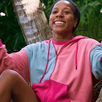 Woman In Pink And Blue Hoodie Smiling GIF