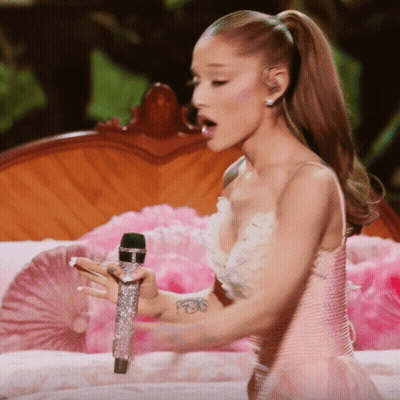 Woman In Pink And White Dress Holding Microphone GIF