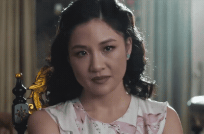 Woman In Pink And White Dress Sitting GIF