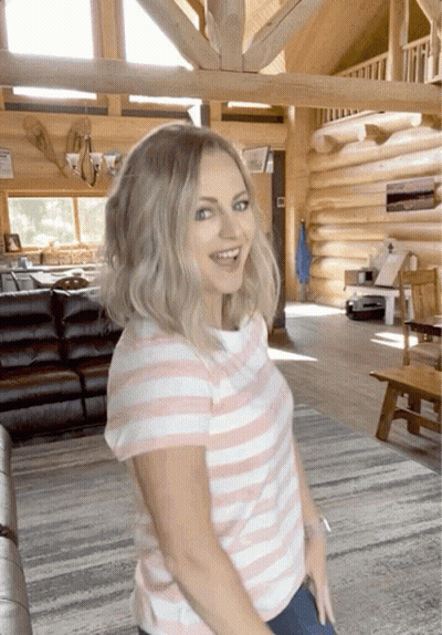 Woman In Pink And White Striped Shirt In Log Cabin GIF