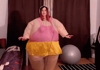 Woman In Pink And Yellow Inflatable Costume With Exercise Ball GIF