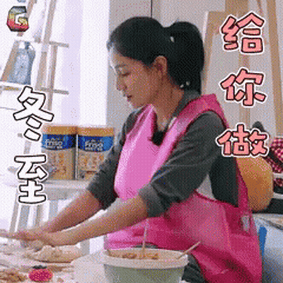 Woman In Pink Apron Preparing Food In Kitchen GIF