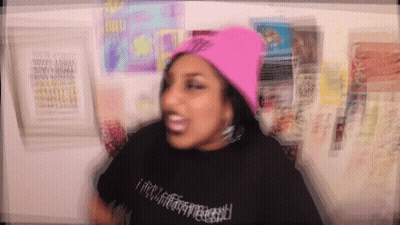 Woman In Pink Beanie And Black T-Shirt GIF
