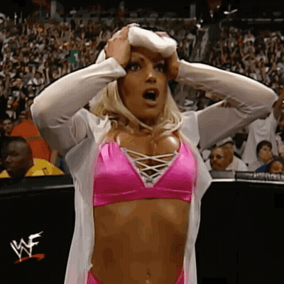Woman In Pink Bikini Holding Head At Wrestling Match GIF