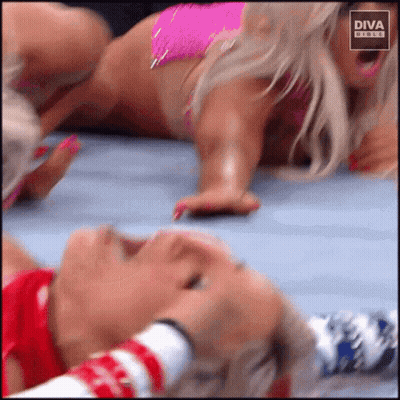 Woman In Pink Bikini Laying On Floor While Another Covers Her Mouth GIF