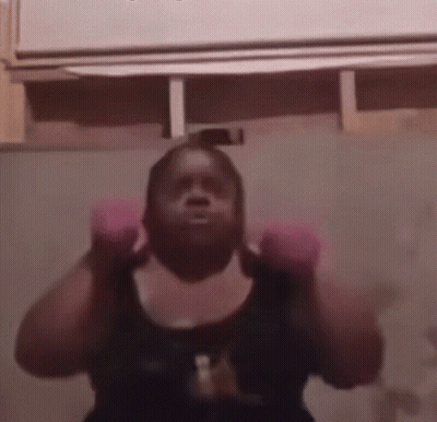 Woman In Pink Boxing Gloves Lifting Weights GIF