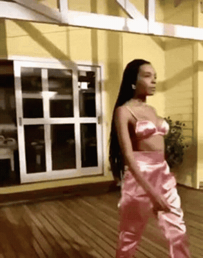 Woman In Pink Bra And Pants On Wooden Deck GIF