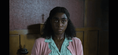 Woman In Pink Cardigan And Gold Necklace GIF