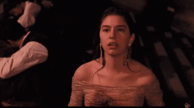 Woman In Pink Dress And Earrings At Camera GIF