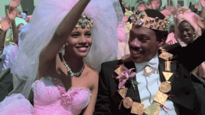 Woman In Pink Dress And Man In Black Suit Smiling GIF