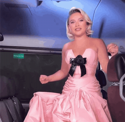 Woman In Pink Dress At Green Exit Sign GIF
