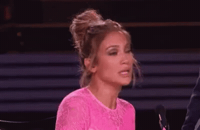 Woman In Pink Dress At Microphone GIF